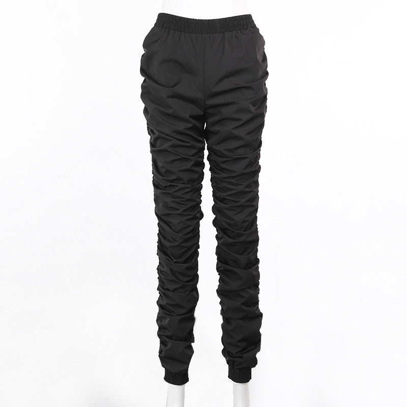 Black quilted pants on a white background