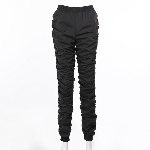 Black quilted pants on a white background