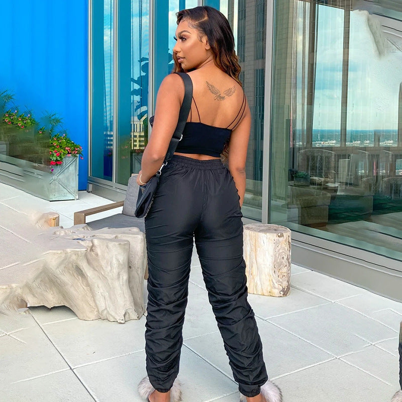 Woman in black outfit standing on a balcony with ocean view