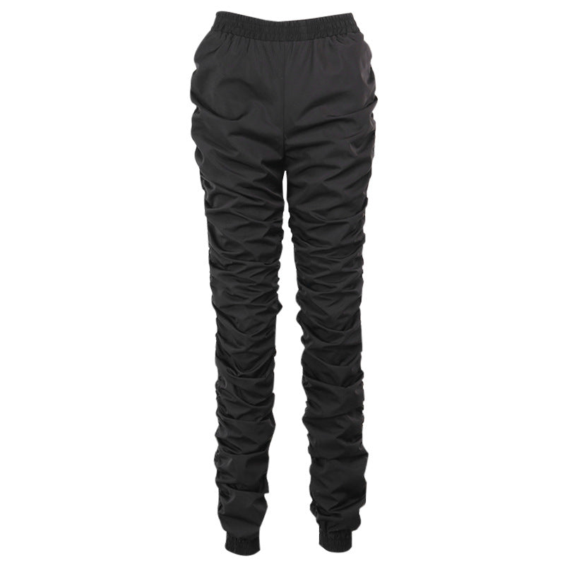 Black ruched pants on a white background